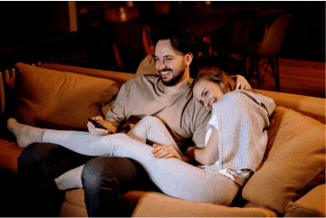 A couple sitting on the couch. bathroom related jitters