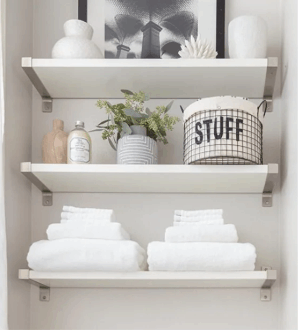 organized towels on shelves in guest bathroom, cleaning your airbnb for success