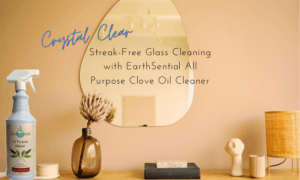 cleaning naturally the magic of clove cleaner 13 A mirror hanging on the wall, a vase with a fluffy white flower and a bottle of EarthSential All Purpose Clove Oil Spray