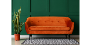 an orange comfy couch, cleaning your airbnb for success
