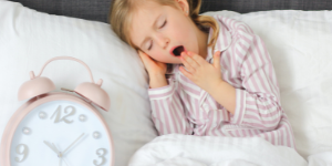a yawning little girl, tires in her bed. Sweet Orange and Lavender Oil for a sound sleep